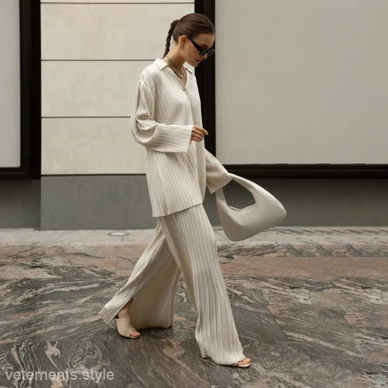 Woman modeling Ava Casual Set featuring a long sleeve top and straight leg pants