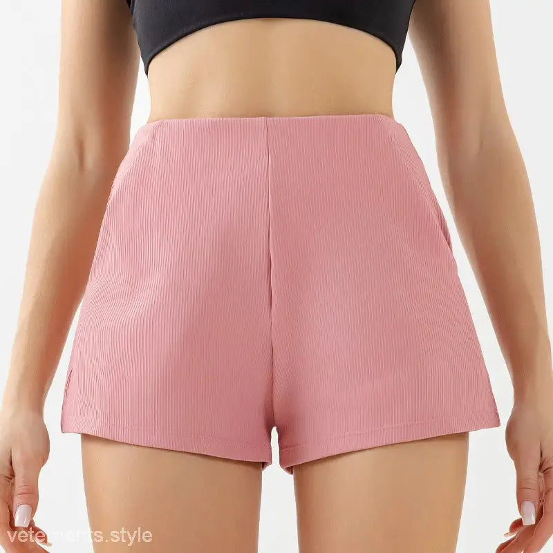 Pink ribbed high waist yoga shorts worn with a black crop top, perfect for comfy high waist yoga shorts