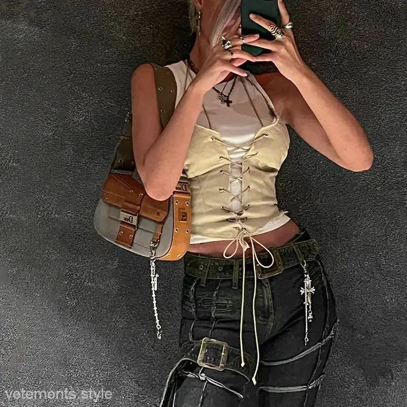 Backless bandage corset top with lace-up front over white shirt, paired with dark pants and accessories