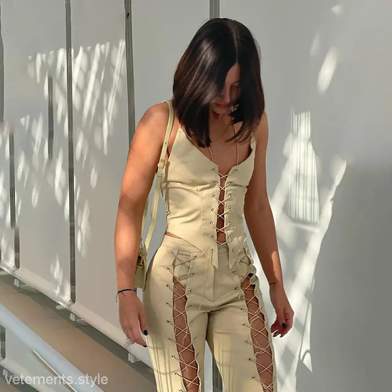 Pale yellow lace-up jumpsuit with revealing cutouts worn by woman, perfect for cowgirl bandage corset style