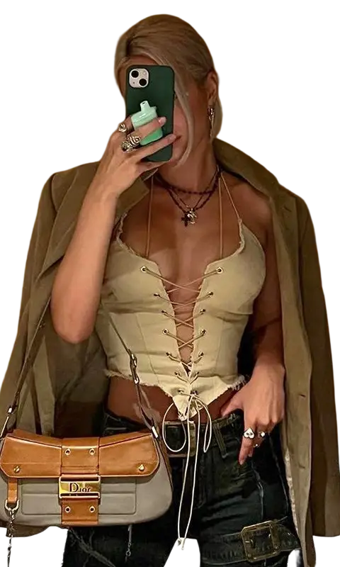 Woman in sexy backless bandage corset taking mirror selfie with handbag