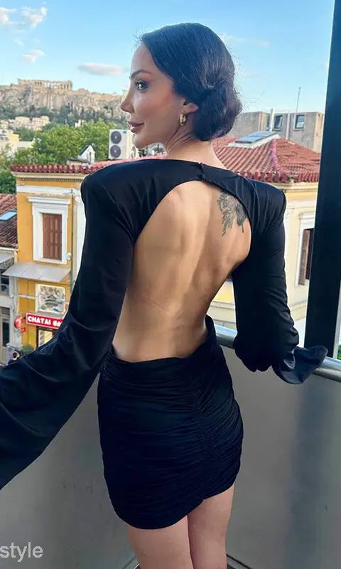 Backless black mini bodycon dress with ruched v-neck and cutout details