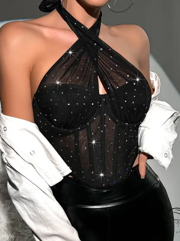 Sparkly black halter top with sheer panels, white jacket, steel ring diamond detail