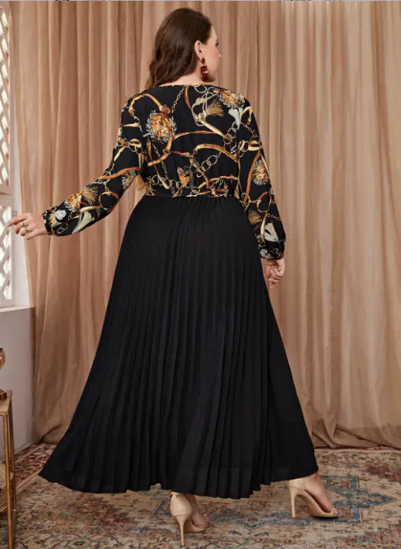 Black pleated maxi dress featuring a chain print top, ideal for a beautiful evening dress