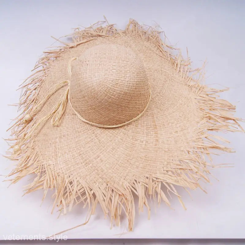 Frayed straw wide-brim sun hat featuring a ribbon band and decoration rose red