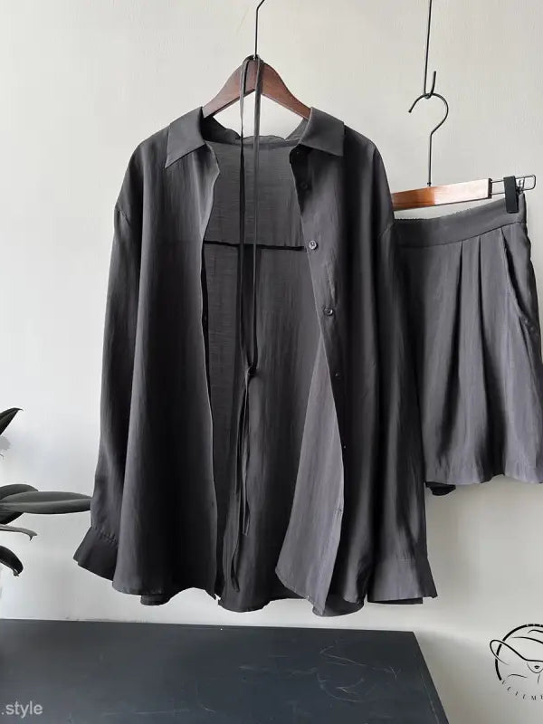 Dark gray belted sun protection shirt suit with shorts on hangers