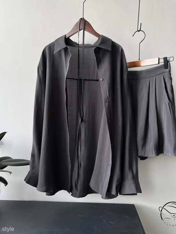 Dark gray belted sun protection shirt suit with shorts on hangers