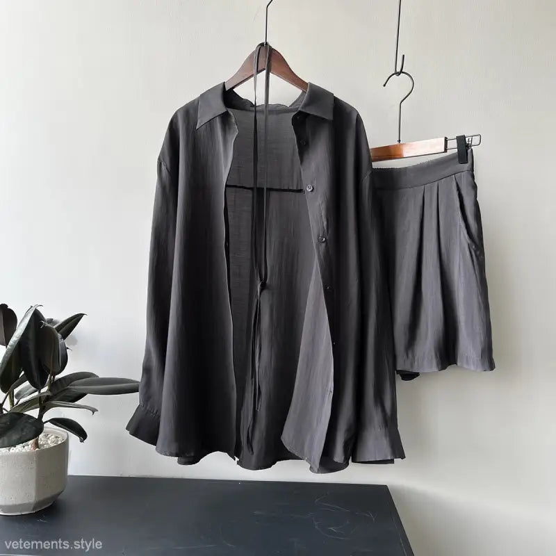 Dark gray breathable sun protection shirt with matching shorts on hangers