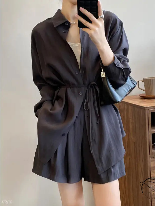 Black button-up sun protection shirt dress with waist tie