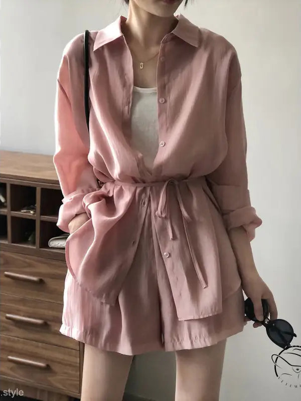 Pink belted sun protection shirt with waist tie over white undershirt