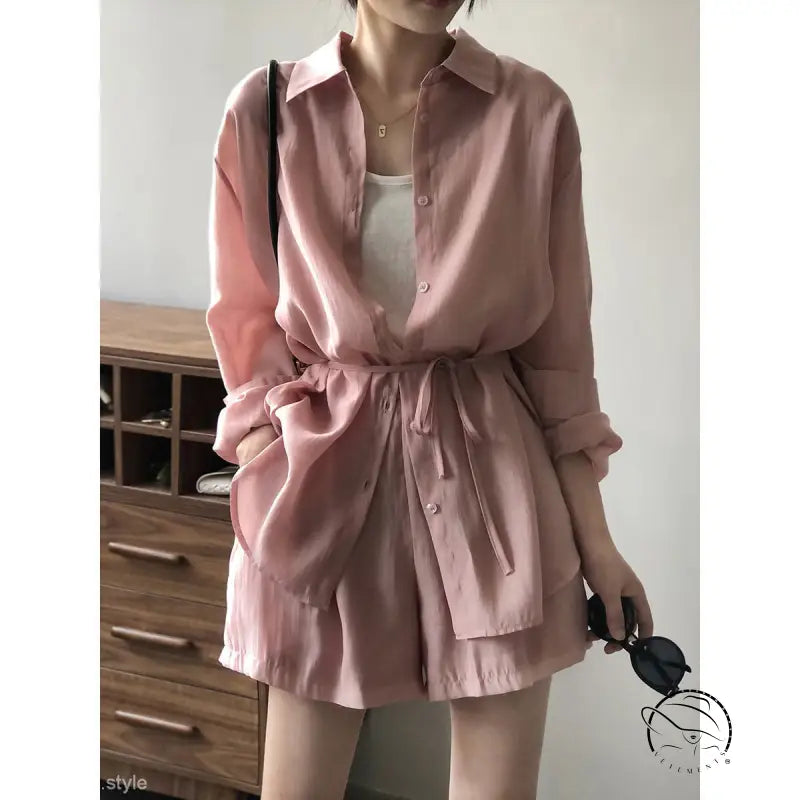 Pink belted sun protection shirt with waist tie over white undershirt