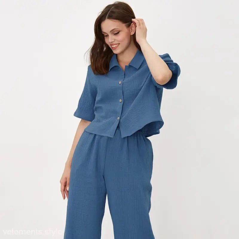 Woman modeling Blue Cotton Confinement Pajamas Set featuring button sleeve top and pants