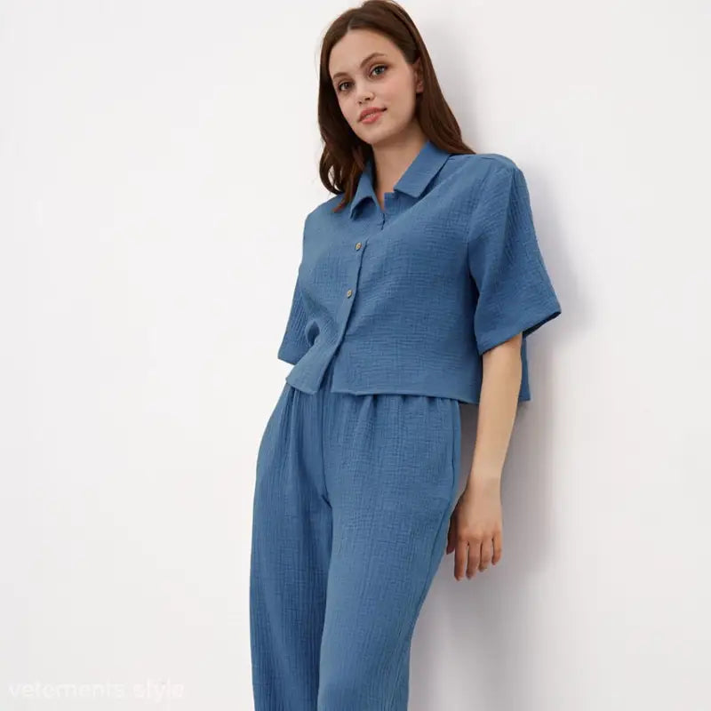 Blue cotton confinement pajamas set featuring a cropped button sleeve top and matching pants