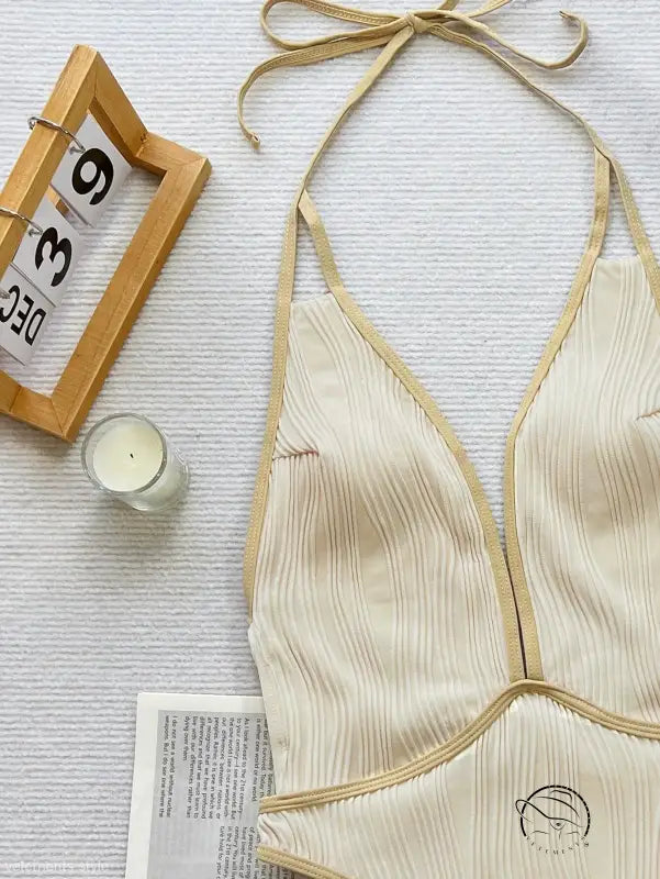 Cream-colored halter top with plunging neckline in white coffee contrast swimsuit