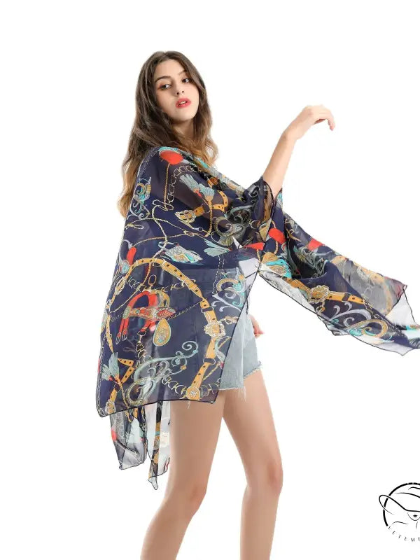 Woman in colorful patterned chiffon swimsuit blouse with wide kimono sleeves