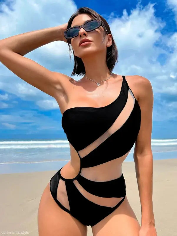 Woman in a black boho color block cutout piece swimsuit with sheer panels, free shipping available