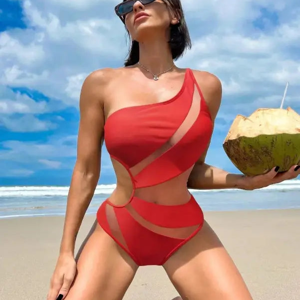 Woman in a red boho color block cutout piece swimsuit holding a coconut drink with free shipping