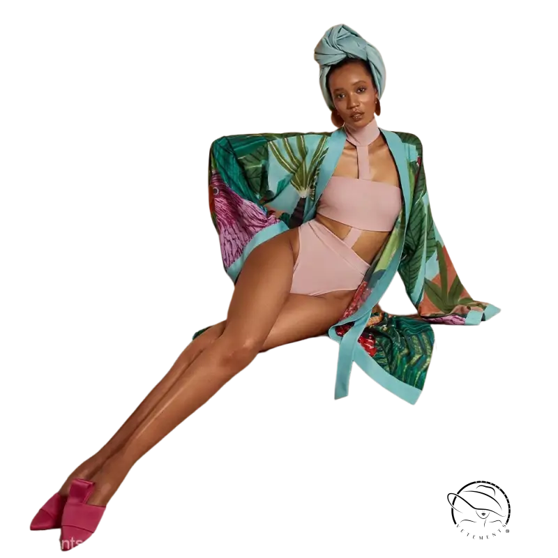 Woman in turquoise tropical kimono trench coat with long sleeves over pink bikini