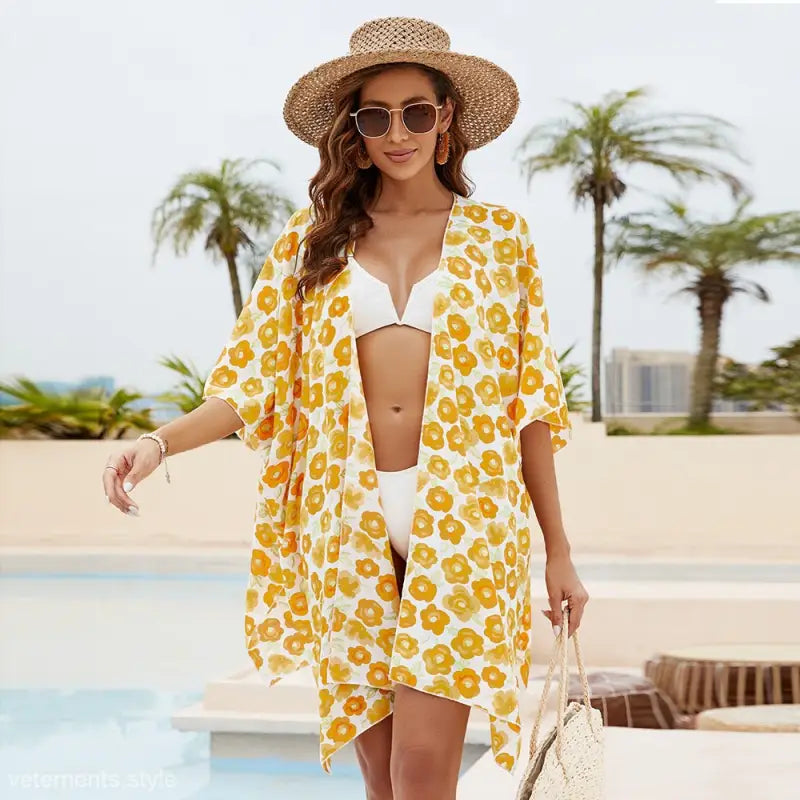Yellow and white floral sun protection blouse with stylish sleeve length over white bikini