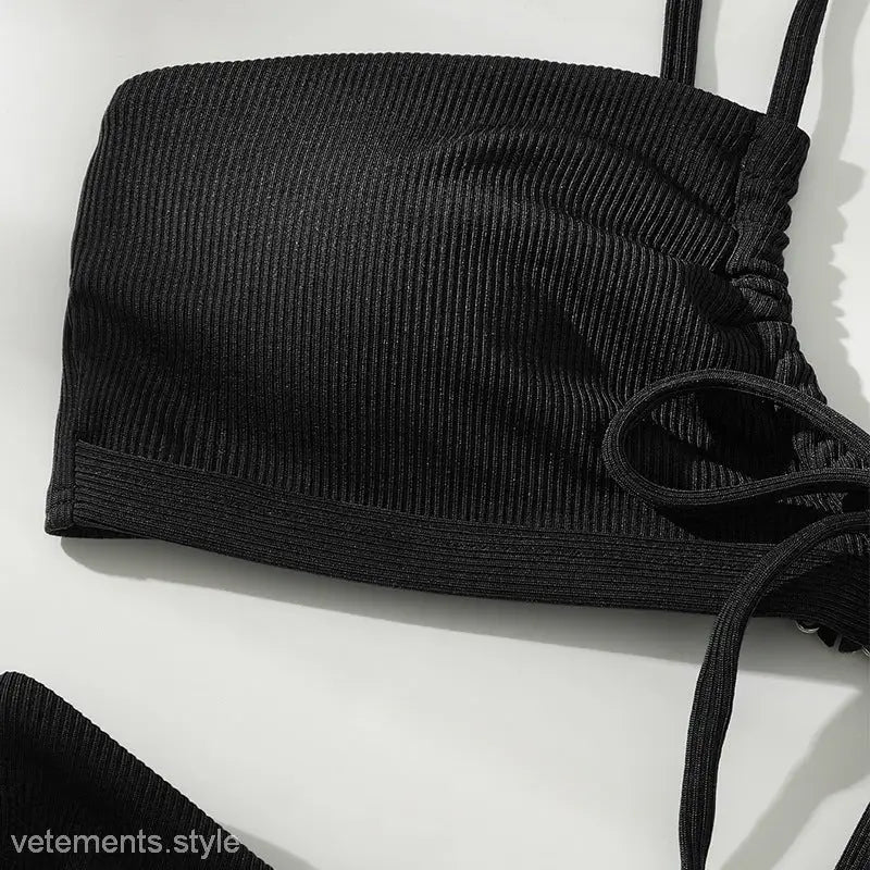 Black ribbed fabric crop top with thin straps for high waist bikini swimsuit style