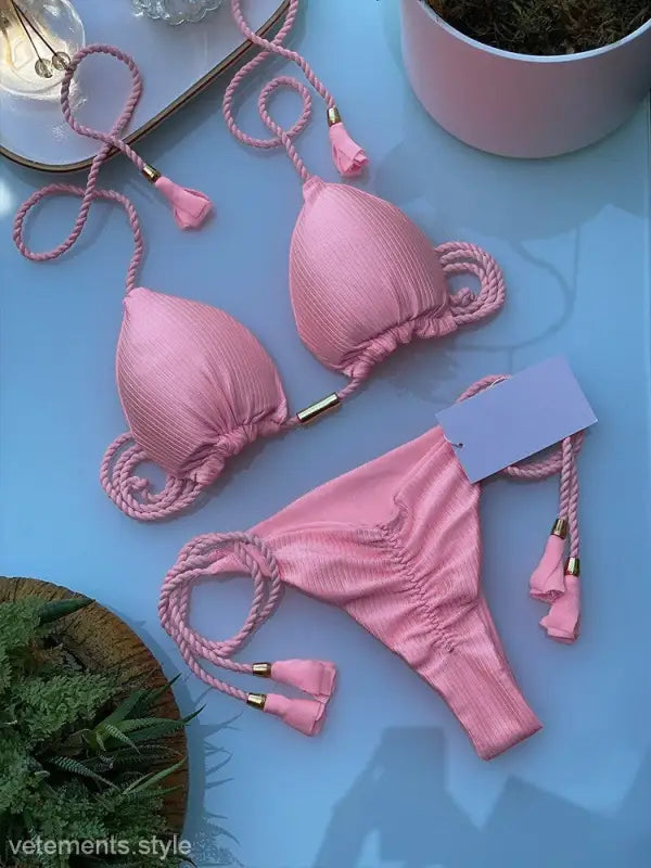 Pink rope swimsuit bikini featuring braided rope straps and tasseled ends