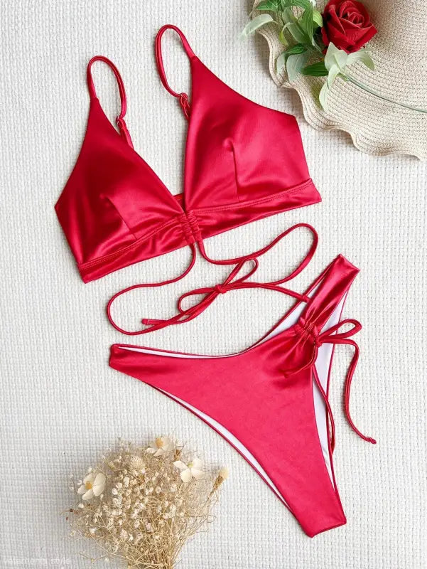 Sexy backless swimsuit in red satin with lace-up sides and tie straps