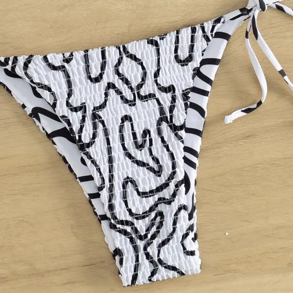 Sexy bikini set with black and white abstract pattern and side ties for summer vacations
