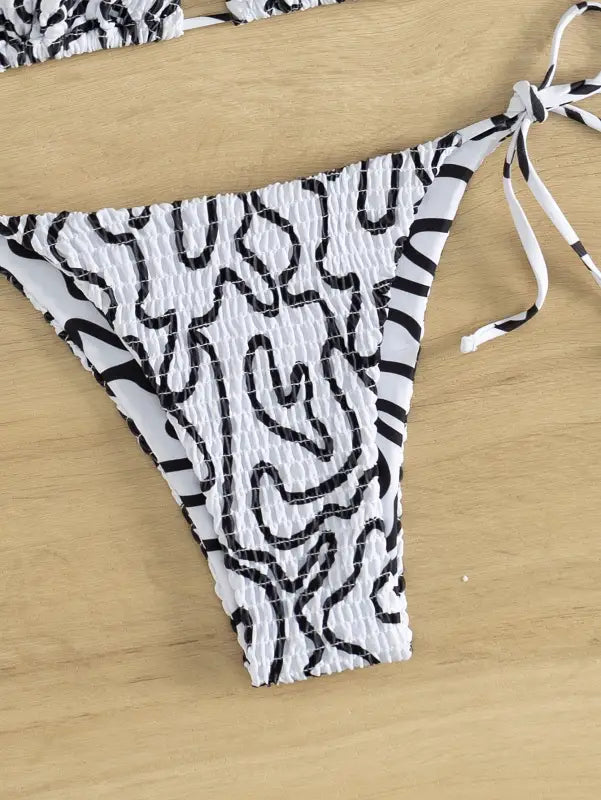 Sexy bikini set with black and white abstract pattern and side ties for summer vacations