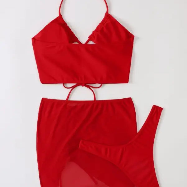 Red three piece bikini featuring ruched design and tie straps for stylish summer vibes