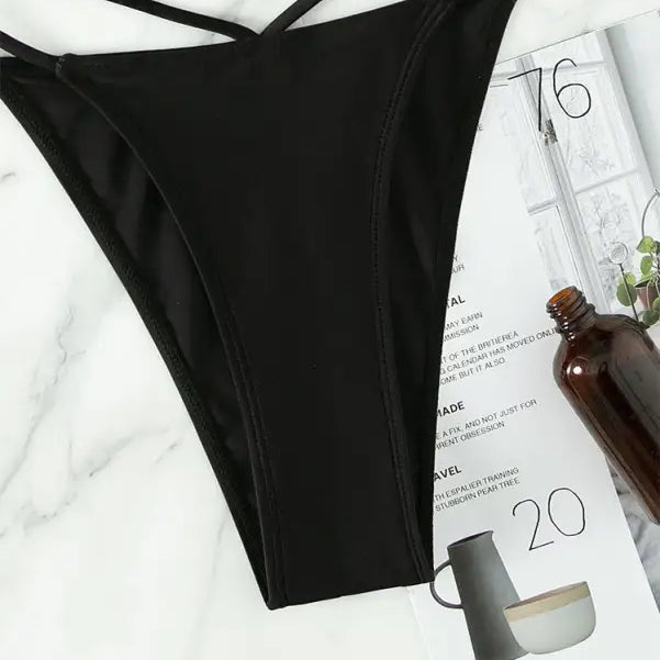 Black crisscross bikini bottom from Boho Small Circle Swimsuit for stylish summer vacations