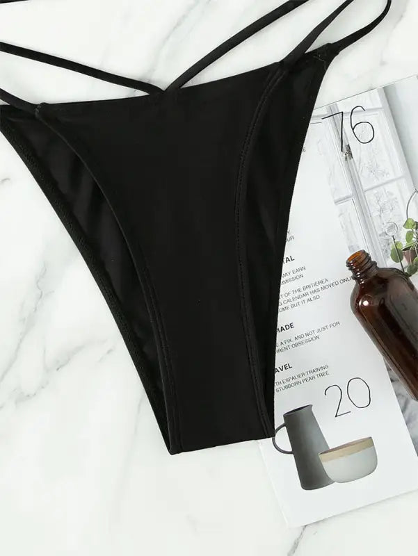 Black crisscross bikini bottom from Boho Small Circle Swimsuit for stylish summer vacations