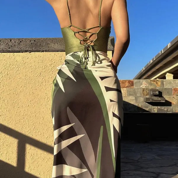 Woman wearing a green jumpsuit and tropical-print sarong, showcasing summer style