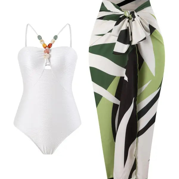 White swimsuit and patterned sarong paired with a wine red jumpsuit for summer style