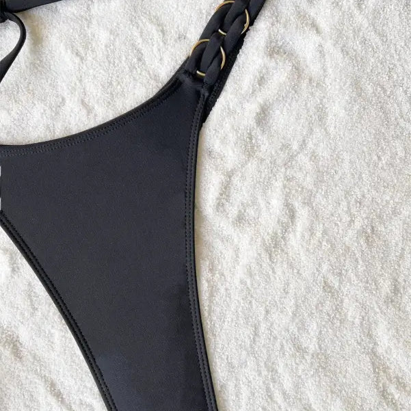 Black swimsuit bottom with gold chain detail from Boho Tie Strap Nylon Swimsuit, perfect for a sexy vacation look