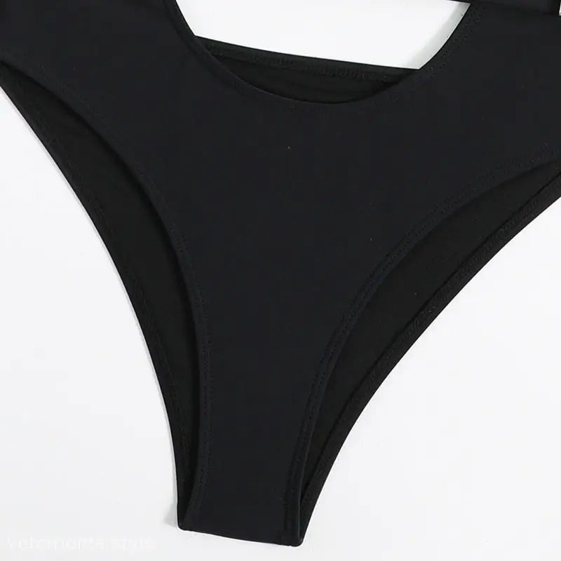Black high-cut bikini bottom from Boho Vacation Cutout Swimsuit with Belted Waist