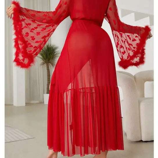 Red sheer dress with bell sleeves and a feathered trim.