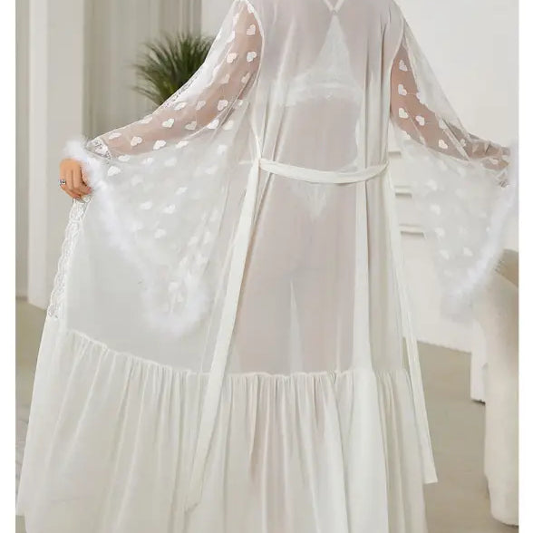 Flowing white sheer robe with polka dot sleeves and a ruffled hem.