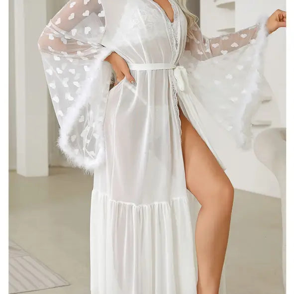 White sheer robe with heart-patterned sleeves and a belted waist.
