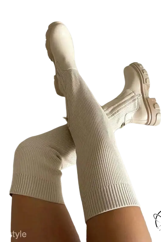Cream-colored British style knee high boots with ribbed knit and fur lining