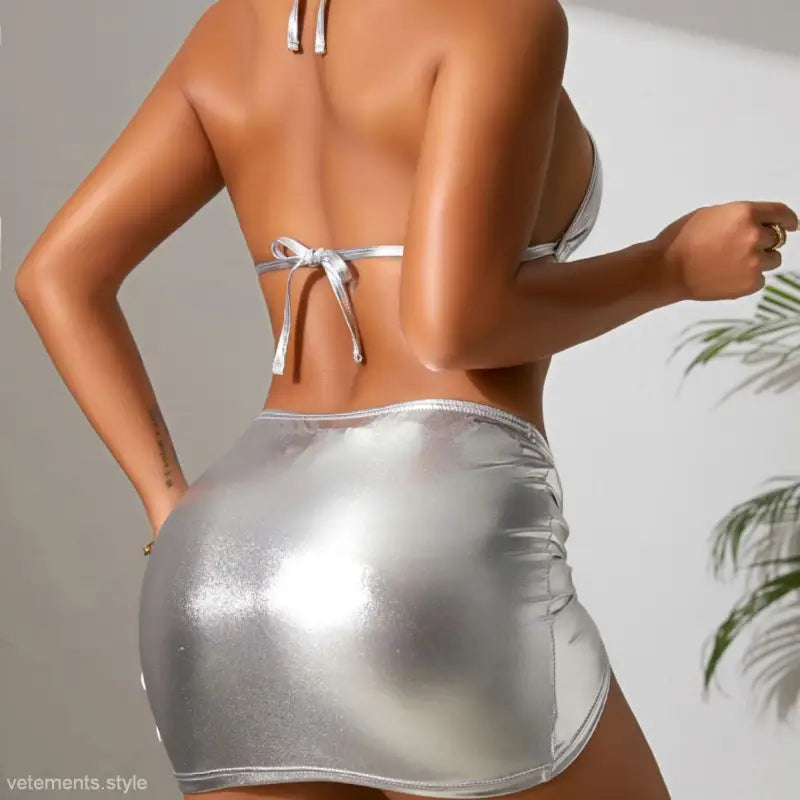 Woman modeling a white bikini top and silver miniskirt in the bronzing bikini three piece swimsuit