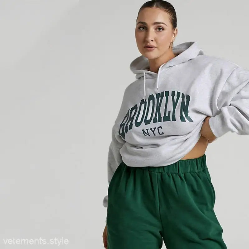 White Brooklyn sweatshirt set featuring green ’BROOKLYN NYC’ print on pullover