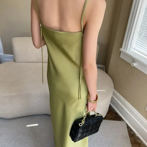 Budding green satin glossy cami dress with black quilted handbag
