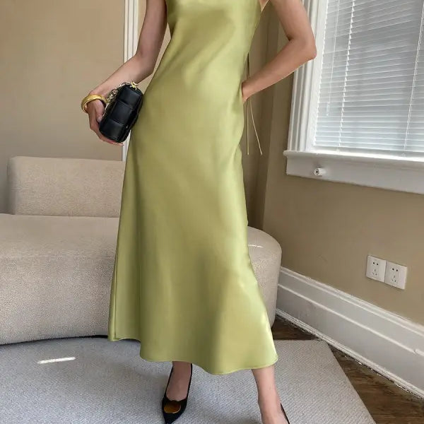 Budding green satin glossy cami dress with spaghetti straps and floor-length drape
