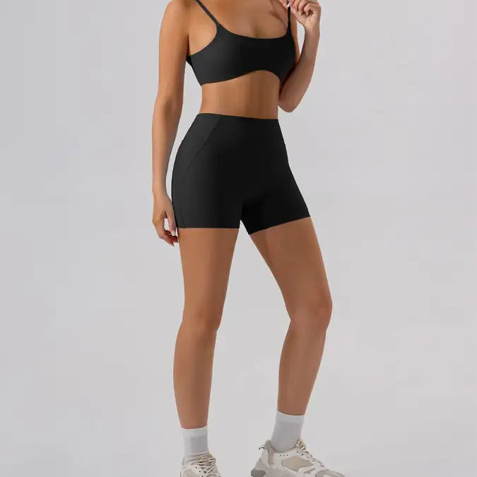 Black athletic bra and burnt tea brown close fitting yoga shorts set for active wear