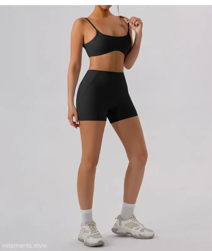 Black athletic bra and burnt tea brown close fitting yoga shorts set for active wear