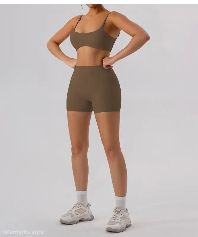 Woman in burnt tea brown athletic set featuring close-fitting yoga outer wear