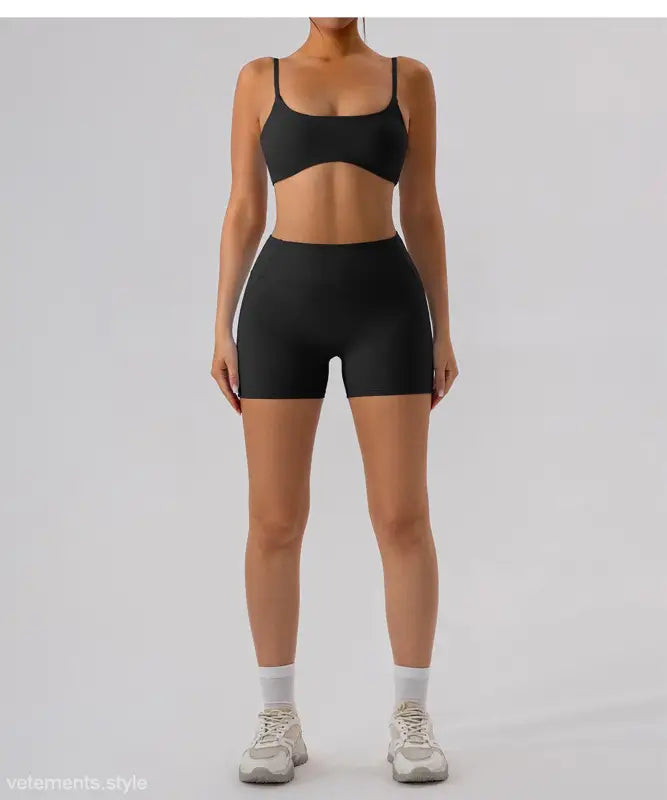 Black athletic bra and shorts set in Burnt Tea Brown close-fitting yoga outer wear