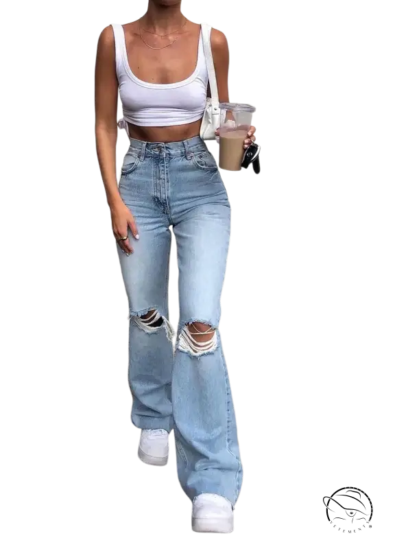 Woman in high waist retro stretch slim ripped jeans and white crop top