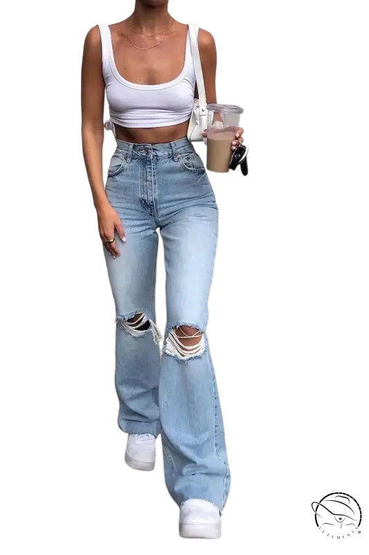 Woman in high waist retro stretch slim ripped jeans and white crop top