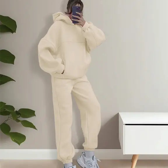 Person wearing casual comfy sweaters two piece winter solid color outfit with gray sneakers